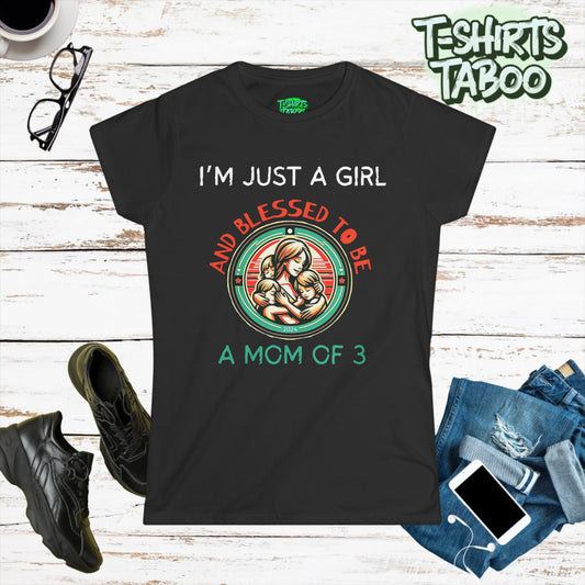 Stylish and unique T-shirt by T-shirts Taboo featuring the slogan I’m just a girl and blessed to be a mom of 3. Also features  round badge like logo graphic of a mom