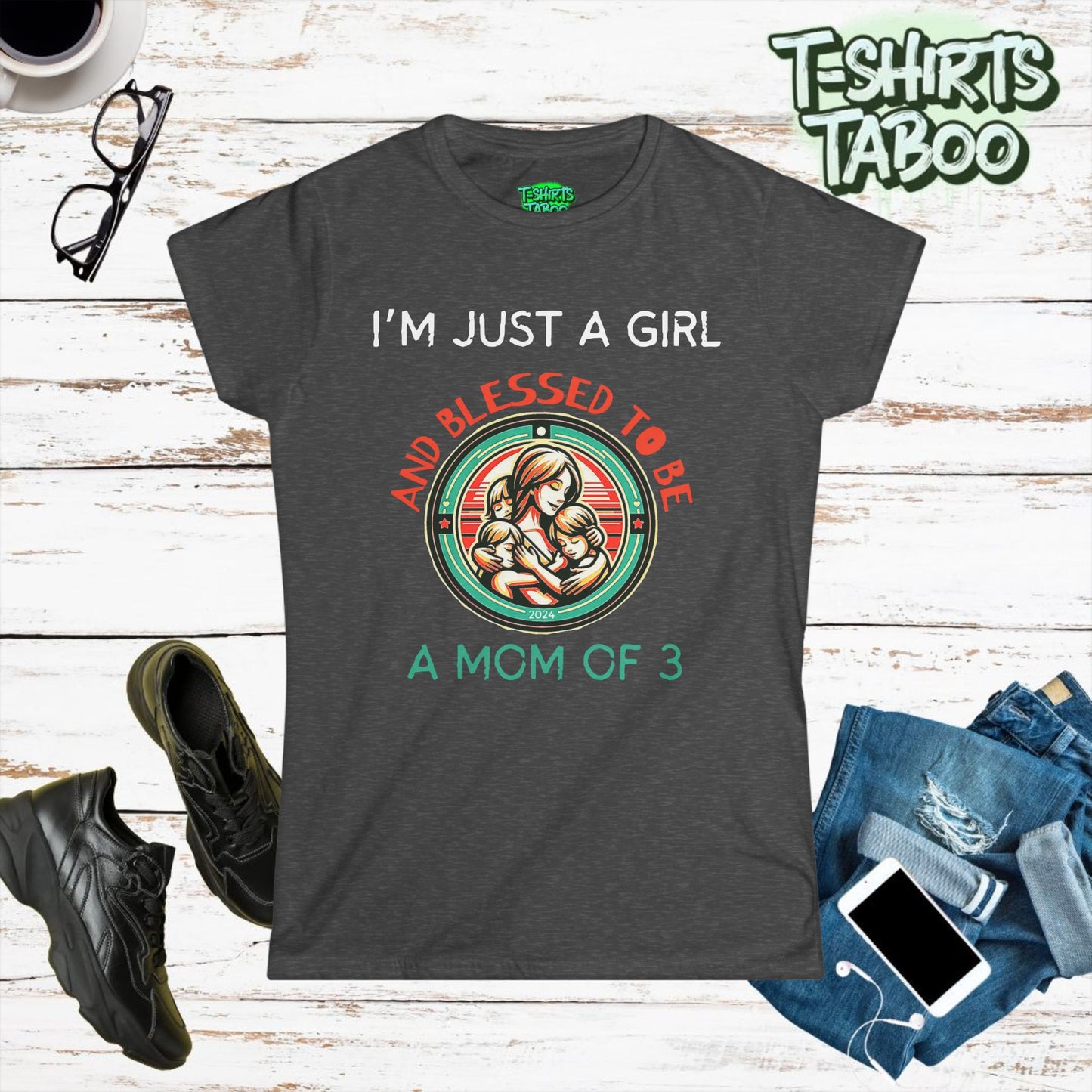 Stylish and unique T-shirt by T-shirts Taboo featuring the slogan I’m just a girl and blessed to be a mom of 3. Also features  round badge like logo graphic of a mom