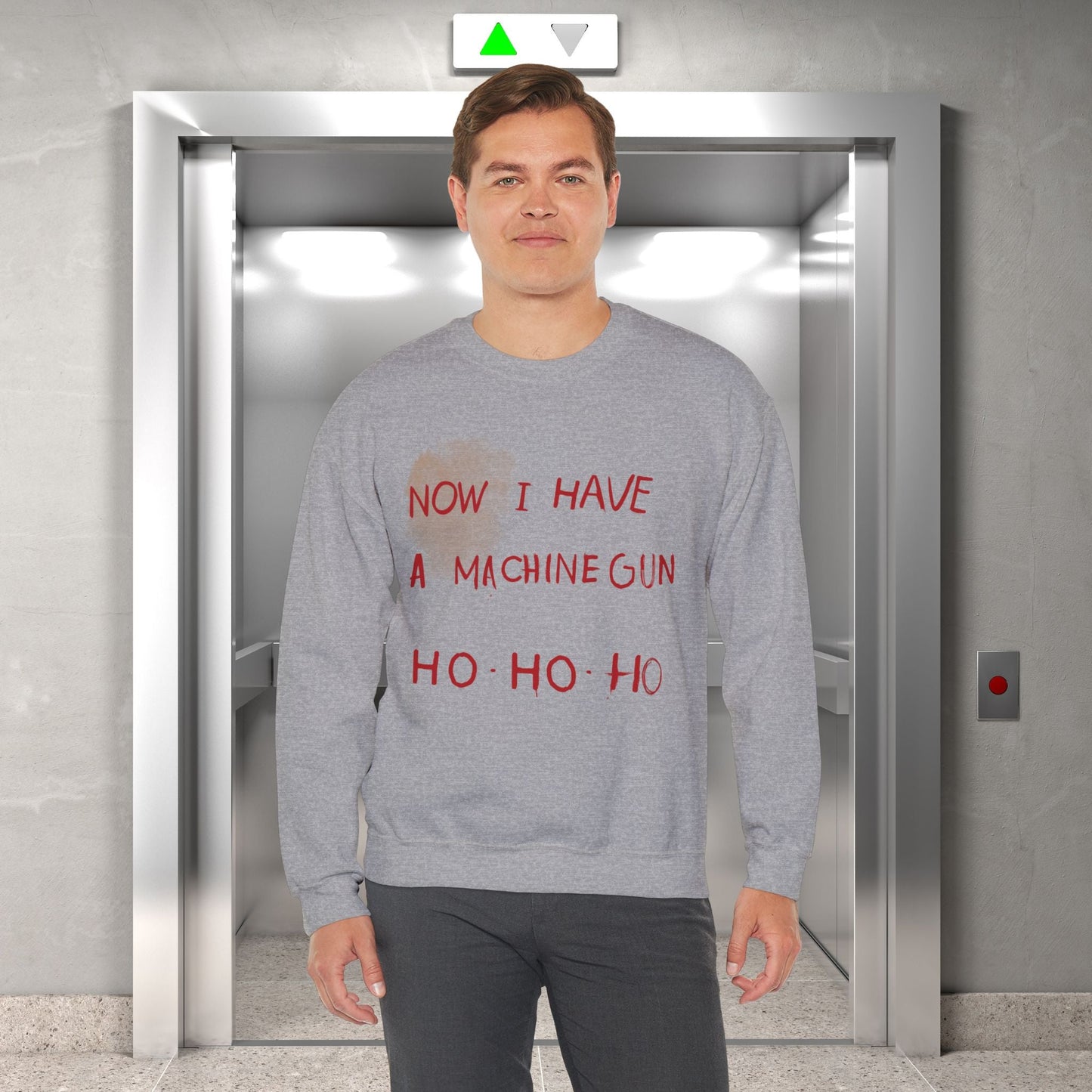 Here at t-shirts Taboo we turned that legendary scene into the most authentic Die Hard Christmas Sweater you've ever laid eyes on.  Image shows a grey christmas sweater with the words "now I have a machine gun ho ho ho"