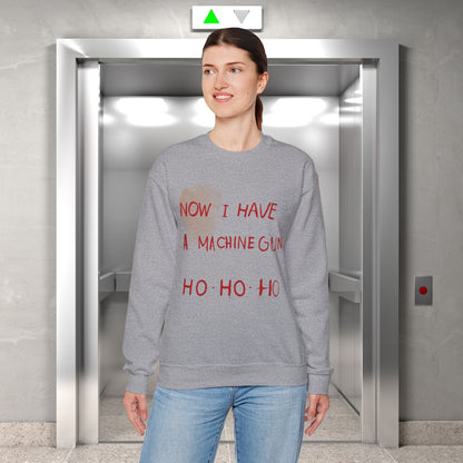 Here at t-shirts Taboo we turned that legendary scene into the most authentic Die Hard Christmas Sweater you've ever laid eyes on.  Image shows a grey christmas sweater with the words "now I have a machine gun ho ho ho"