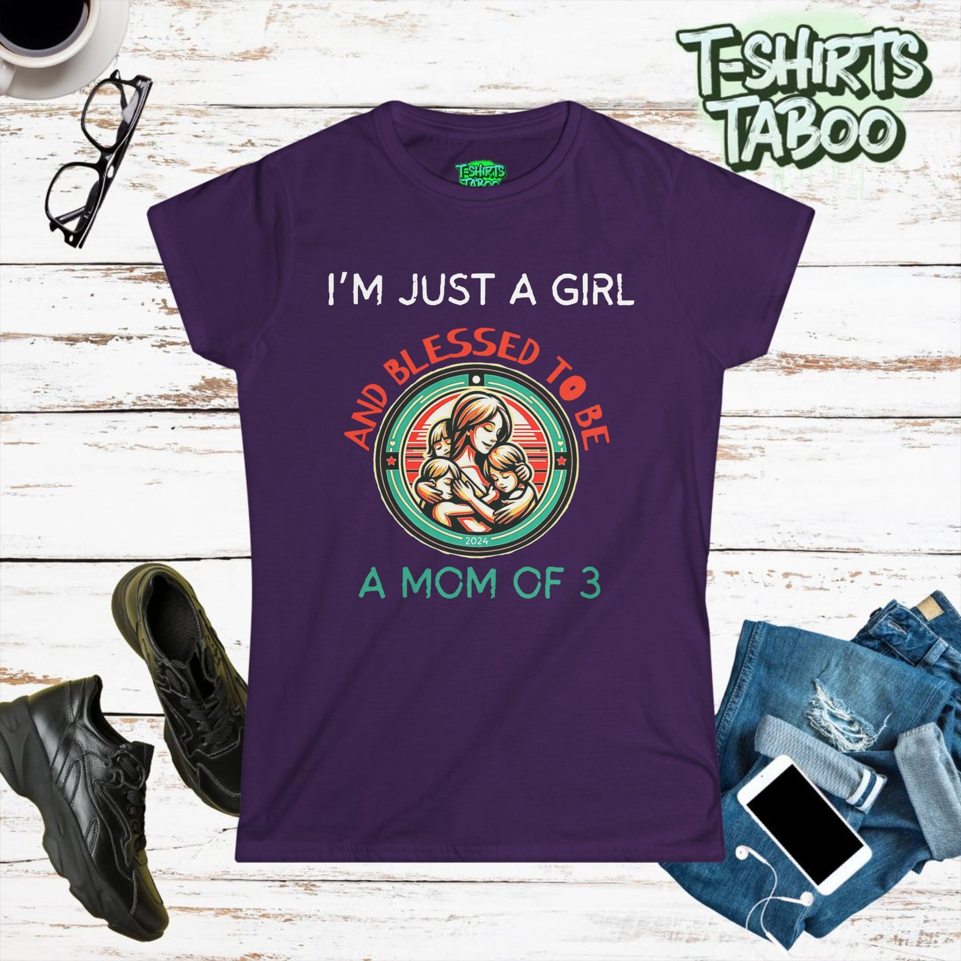 Stylish and unique T-shirt by T-shirts Taboo featuring the slogan I’m just a girl and blessed to be a mom of 3. Also features  round badge like logo graphic of a mom